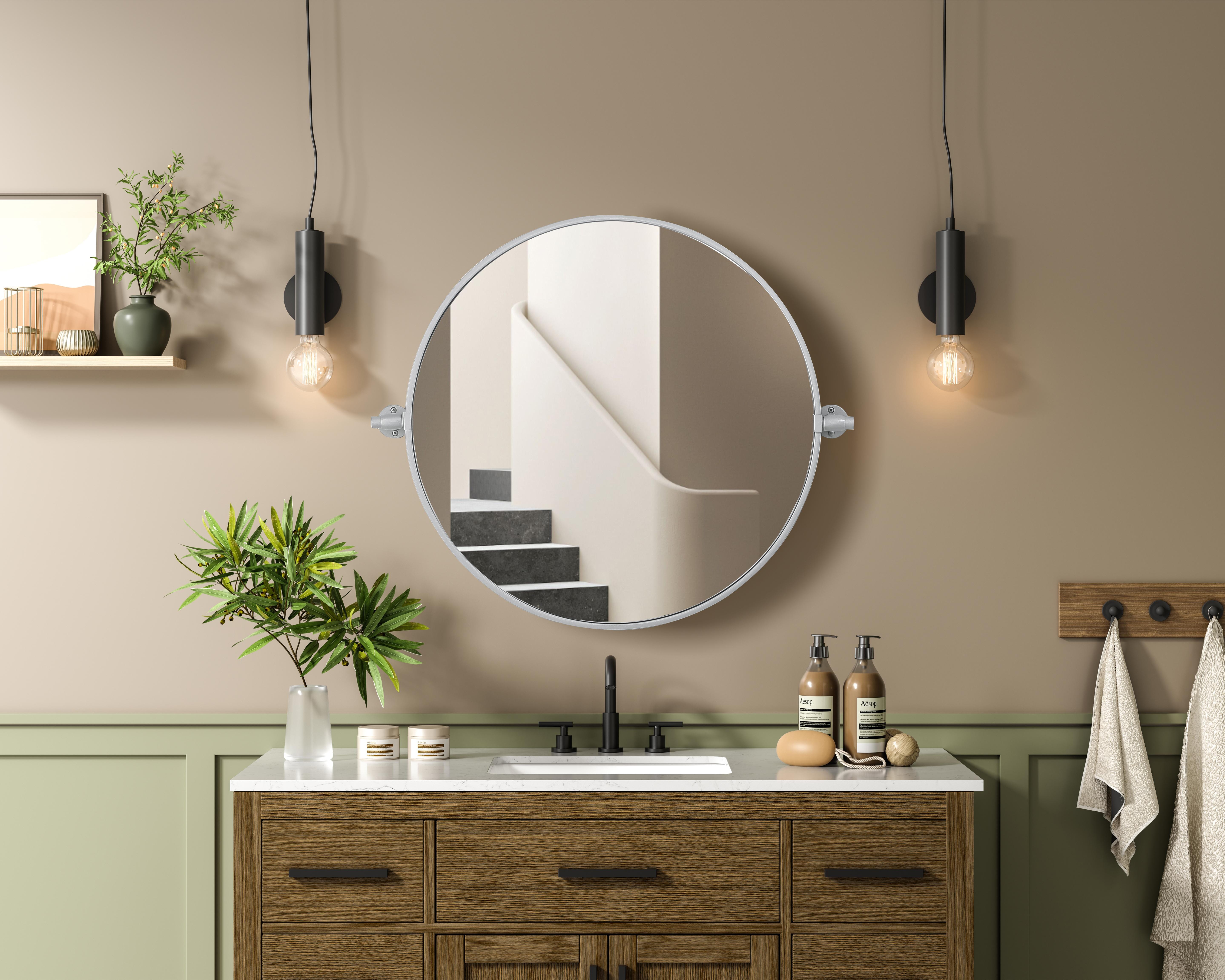 Elevate your space with the perfect blend of form and function—this sleek pivot mirror is designed to move with you. Crafted from durable iron with a sturdy MDF backing, it offers both stability and style. The 8-degree adjustable pivot allows for a customized viewing angle, making it ideal for bathrooms, bedrooms, and beyond. Finished with a hand-painted touch, this mirror is available in three elegant shades: black, silver, and brass, effortlessly complementing a range of interior aesthetics. Its modern round silhouette brings a timeless, minimalist appeal, making it a versatile piece for any room—whether placed in a living room, office, or entryway. Designed for effortless installation, this mirror comes with all necessary mounting brackets and screws, so you can upgrade your space in minutes. Whether you're seeking a functional bathroom essential or a sophisticated statement piece, this adjustable pivot mirror delivers in both style and practicality. Collection: Amoura Rooms: Bathroom Finish: Silver Width: 24.00" Height: 24.00" Weight: 10.00 lb Extension from Wall: 3.00" Material: Iron and MDF Country of Origin: China Safety Rating: Damp Manufacturer Warranty: 1 year limited - alternate view
