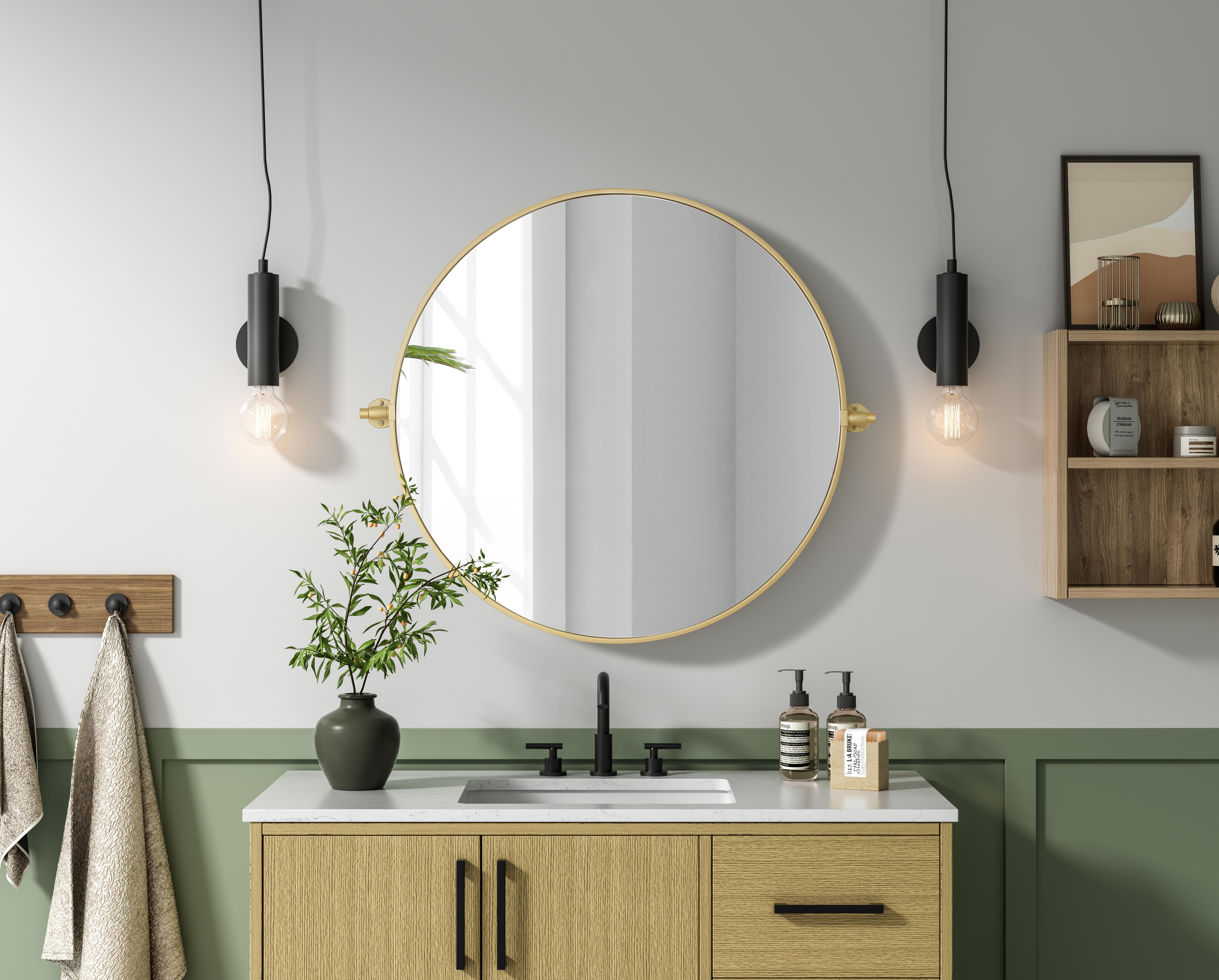 Elevate your space with the perfect blend of form and function—this sleek pivot mirror is designed to move with you. Crafted from durable iron with a sturdy MDF backing, it offers both stability and style. The 8-degree adjustable pivot allows for a customized viewing angle, making it ideal for bathrooms, bedrooms, and beyond. Finished with a hand-painted touch, this mirror is available in three elegant shades: black, silver, and brass, effortlessly complementing a range of interior aesthetics. Its modern round silhouette brings a timeless, minimalist appeal, making it a versatile piece for any room—whether placed in a living room, office, or entryway. Designed for effortless installation, this mirror comes with all necessary mounting brackets and screws, so you can upgrade your space in minutes. Whether you're seeking a functional bathroom essential or a sophisticated statement piece, this adjustable pivot mirror delivers in both style and practicality. Collection: Amoura Rooms: Bathroom Finish: Brass Width: 30.00" Height: 30.00" Weight: 16.00 lb Extension from Wall: 3.00" Material: Iron and MDF Country of Origin: China Safety Rating: Damp Manufacturer Warranty: 1 year limited - alternate view