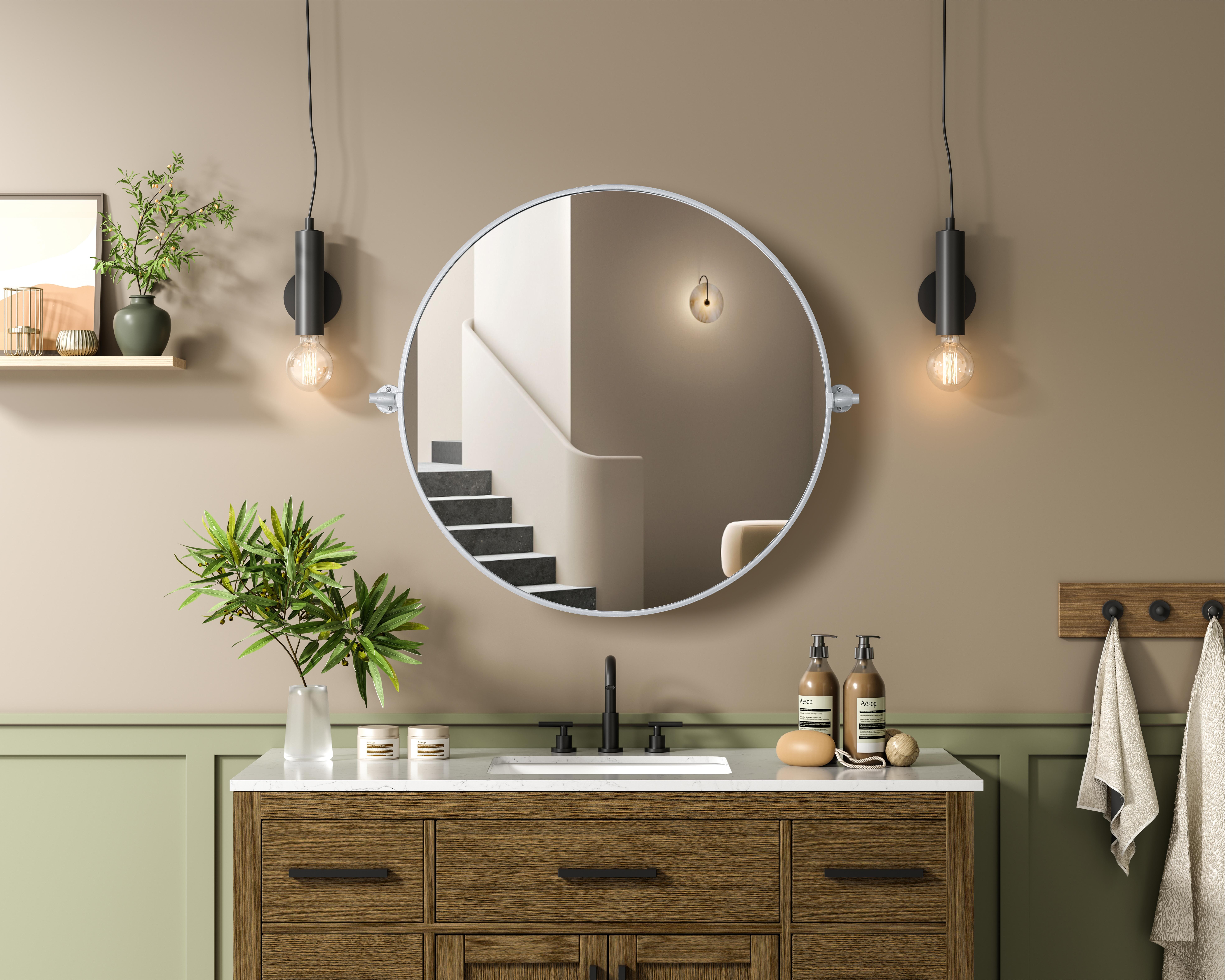 Elevate your space with the perfect blend of form and function—this sleek pivot mirror is designed to move with you. Crafted from durable iron with a sturdy MDF backing, it offers both stability and style. The 8-degree adjustable pivot allows for a customized viewing angle, making it ideal for bathrooms, bedrooms, and beyond. Finished with a hand-painted touch, this mirror is available in three elegant shades: black, silver, and brass, effortlessly complementing a range of interior aesthetics. Its modern round silhouette brings a timeless, minimalist appeal, making it a versatile piece for any room—whether placed in a living room, office, or entryway. Designed for effortless installation, this mirror comes with all necessary mounting brackets and screws, so you can upgrade your space in minutes. Whether you're seeking a functional bathroom essential or a sophisticated statement piece, this adjustable pivot mirror delivers in both style and practicality. Collection: Amoura Rooms: Bathroom Finish: Silver Width: 30.00" Height: 30.00" Weight: 16.00 lb Extension from Wall: 3.00" Material: Iron and MDF Country of Origin: China Safety Rating: Damp Manufacturer Warranty: 1 year limited - alternate view