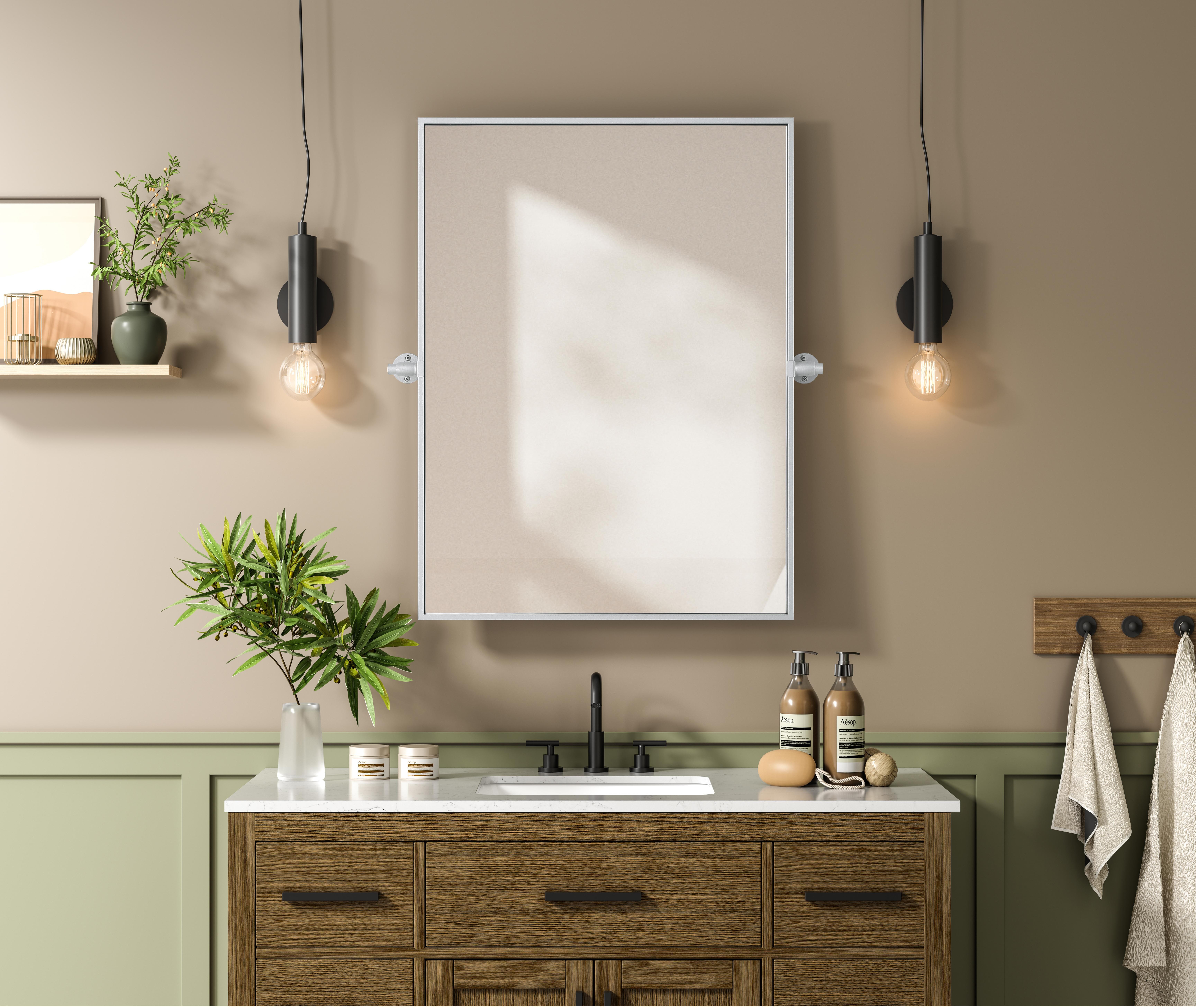 Upgrade your space with a modern pivot mirror that offers both form and function. Featuring an adjustable 8-degree tilt, this mirror allows you to customize your viewing angle for convenience and style. The iron frame with MDF backing ensures durability, while the hand-painted finish—available in black, silver, and brass—adds a touch of sophistication. Designed for versatility, this rectangular mirror can be mounted vertically or horizontally, making it the perfect fit for bathrooms, bedrooms, offices, and more. Its slim metal frame provides a sleek, contemporary aesthetic that blends seamlessly into various design styles. With included mounting brackets and screws, installation is simple and secure, giving your space an instant refresh. Whether you're getting ready for the day or enhancing your home décor, this pivot mirror delivers both style and practicality. Collection: Amoura Rooms: Bathroom Finish: Silver Width: 24.00" Height: 32.00" Weight: 17.00 lb Extension from Wall: 3.00" Material: Iron and MDF Country of Origin: China Safety Rating: Damp Manufacturer Warranty: 1 year limited - alternate view