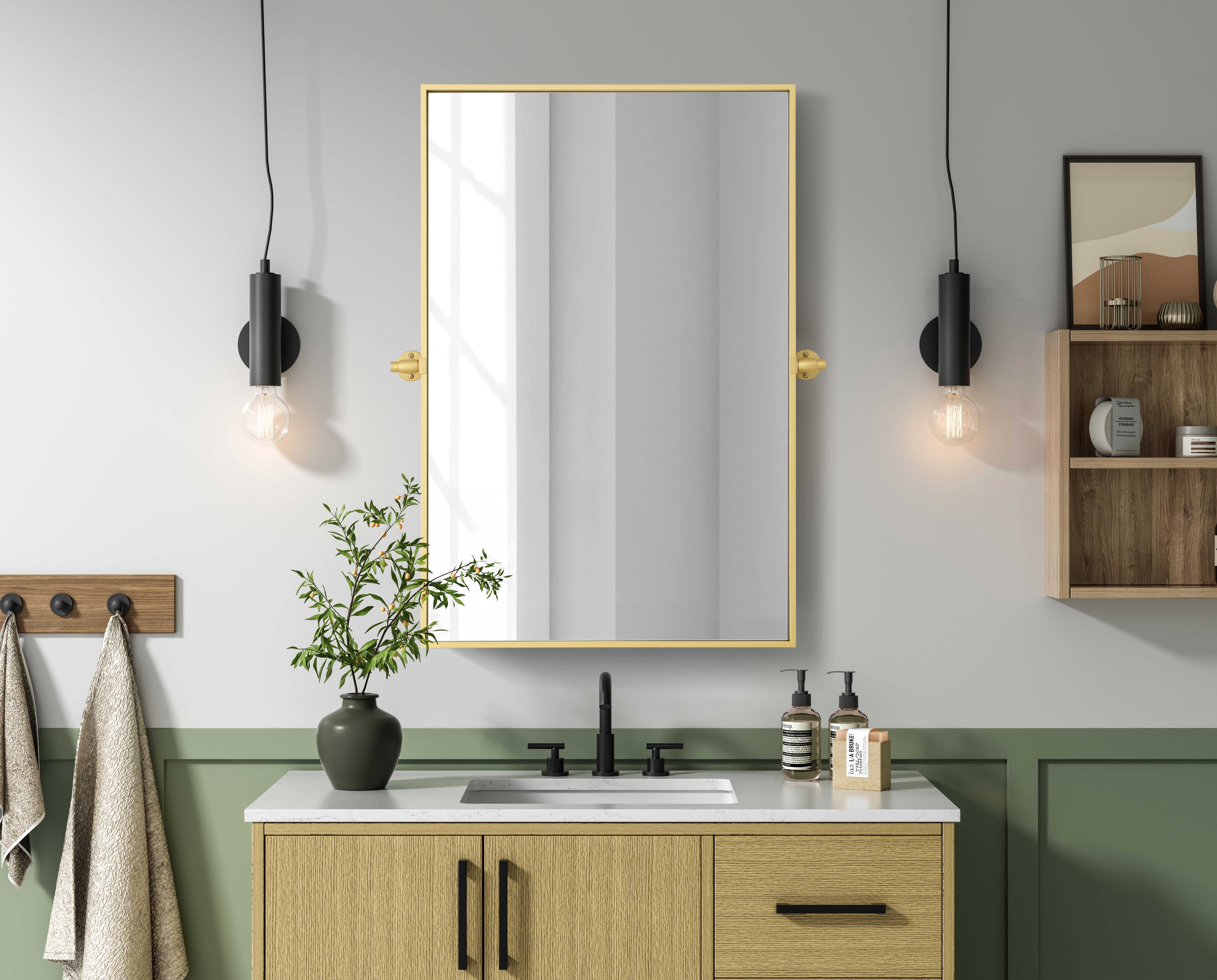 Upgrade your space with a modern pivot mirror that offers both form and function. Featuring an adjustable 8-degree tilt, this mirror allows you to customize your viewing angle for convenience and style. The iron frame with MDF backing ensures durability, while the hand-painted finish—available in black, silver, and brass—adds a touch of sophistication. Designed for versatility, this rectangular mirror can be mounted vertically or horizontally, making it the perfect fit for bathrooms, bedrooms, offices, and more. Its slim metal frame provides a sleek, contemporary aesthetic that blends seamlessly into various design styles. With included mounting brackets and screws, installation is simple and secure, giving your space an instant refresh. Whether you're getting ready for the day or enhancing your home décor, this pivot mirror delivers both style and practicality. Collection: Amoura Rooms: Bathroom Finish: Brass Width: 24.00" Height: 36.00" Weight: 20.00 lb Extension from Wall: 3.00" Material: Iron and MDF Country of Origin: China Safety Rating: Damp Manufacturer Warranty: 1 year limited - alternate view