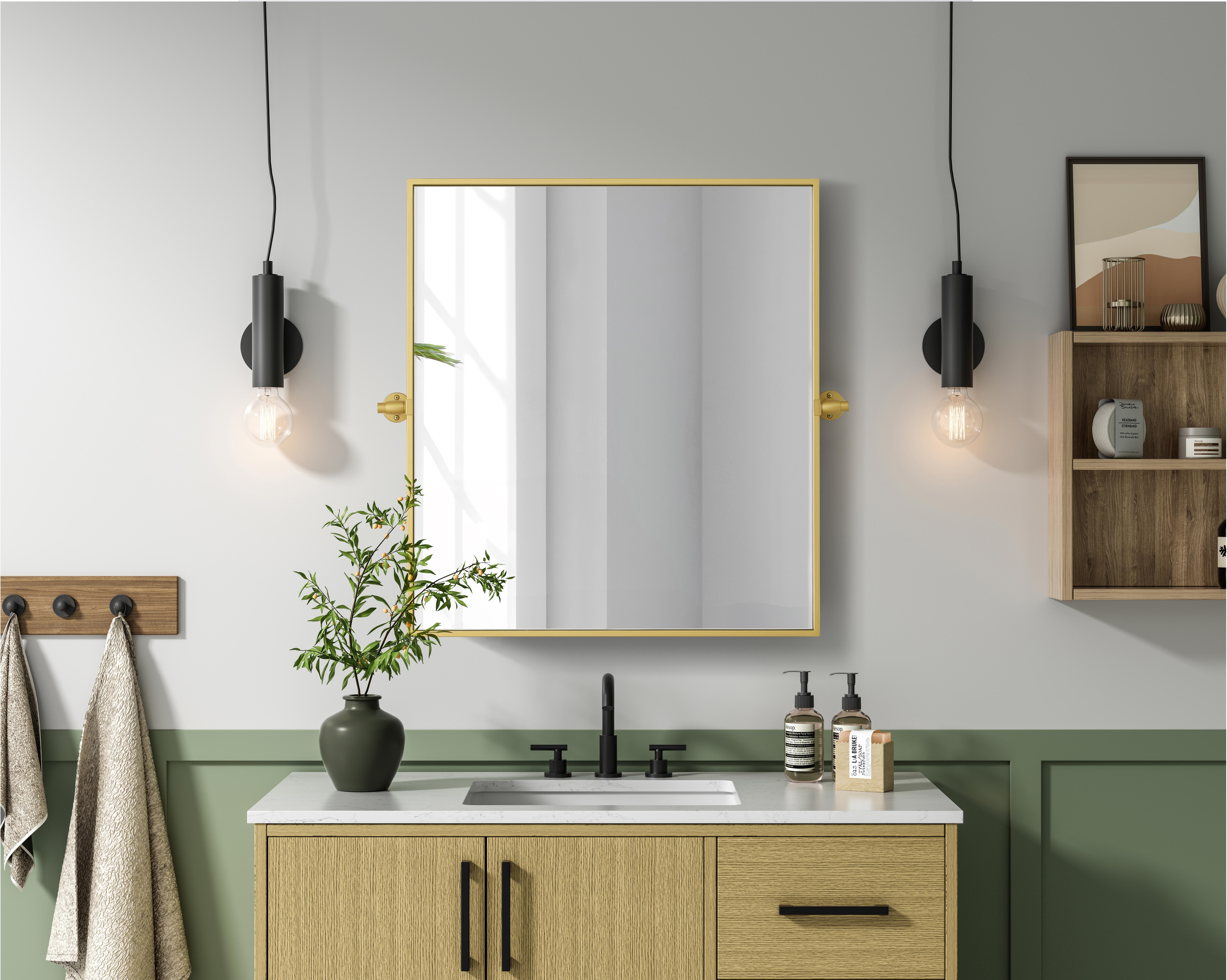 Upgrade your space with a modern pivot mirror that offers both form and function. Featuring an adjustable 8-degree tilt, this mirror allows you to customize your viewing angle for convenience and style. The iron frame with MDF backing ensures durability, while the hand-painted finish—available in black, silver, and brass—adds a touch of sophistication. Designed for versatility, this rectangular mirror can be mounted vertically or horizontally, making it the perfect fit for bathrooms, bedrooms, offices, and more. Its slim metal frame provides a sleek, contemporary aesthetic that blends seamlessly into various design styles. With included mounting brackets and screws, installation is simple and secure, giving your space an instant refresh. Whether you're getting ready for the day or enhancing your home décor, this pivot mirror delivers both style and practicality. Collection: Amoura Rooms: Bathroom Finish: Brass Width: 27.00" Height: 30.00" Weight: 18.00 lb Extension from Wall: 3.00" Material: Iron and MDF Country of Origin: China Safety Rating: Damp Manufacturer Warranty: 1 year limited - alternate view