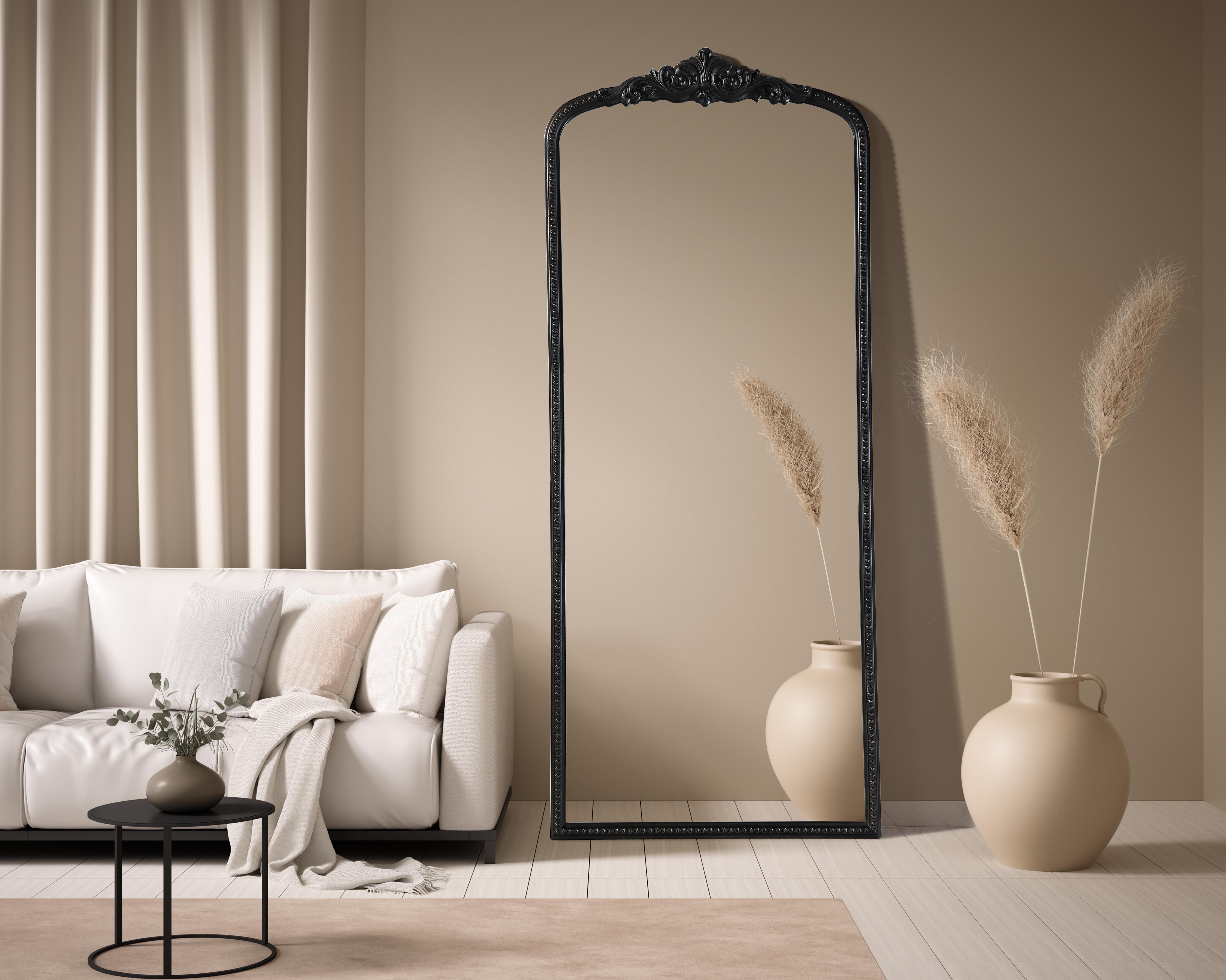 This full-length arched mirror brings a timeless, vintage-inspired charm to any space. The hand-painted vintage bronze finish and ornate crest detailing create a classic European look, perfect for traditional and French-inspired interiors. Whether leaned against the wall for a relaxed aesthetic or securely mounted using the metal inset hanger, this mirror offers versatility and refined style. Constructed from lightweight yet durable resin with an MDF backing board, it ensures long-lasting support and stability. Available in multiple sizes, this mirror is an ideal choice for bedrooms, entryways, and dressing areas, adding depth, light, and an elegant architectural presence to any room. Collection: Naomi Rooms: entry way, living room, dining room, bedroom, office Finish: Vintage Bronze Width: 30.00" Height: 72.00" Weight: 43.00 lb Material: Resin Country of Origin: Vietnam Manufacturer Warranty: 1 year limited - alternate view